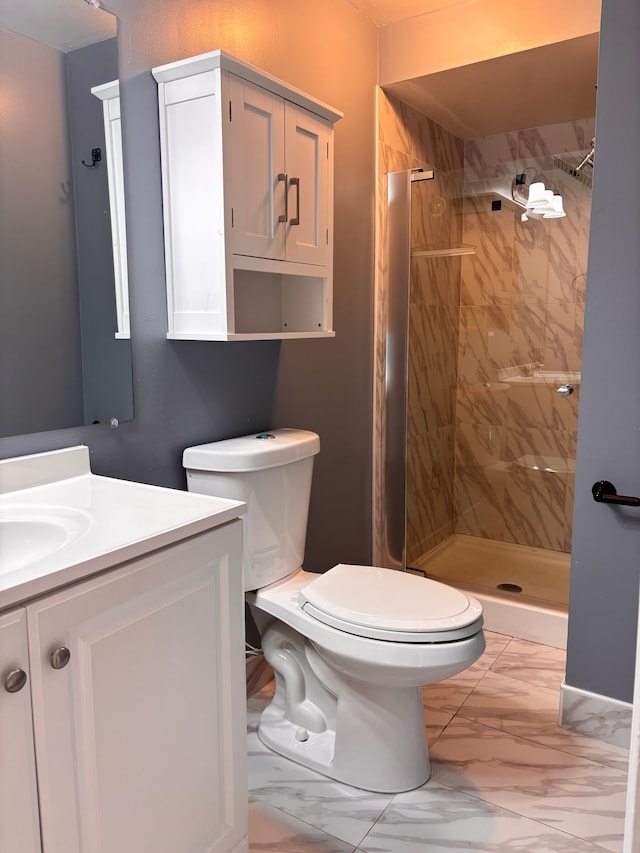 bathroom featuring vanity, toilet, marble finish floor, and a stall shower