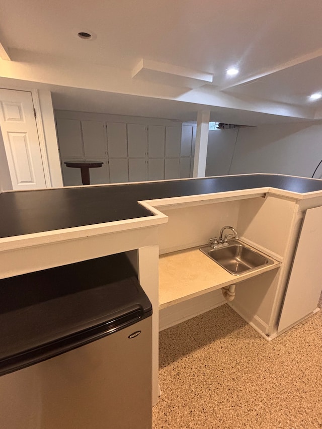 interior details with recessed lighting, speckled floor, and a sink