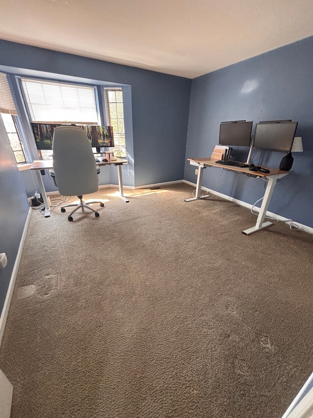 unfurnished office with baseboards and carpet