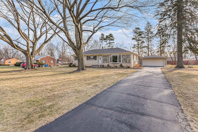 view of front of house with a garage, brick siding, and a front lawn