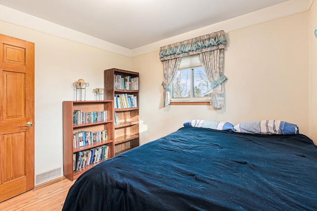 bedroom with wood finished floors and baseboards