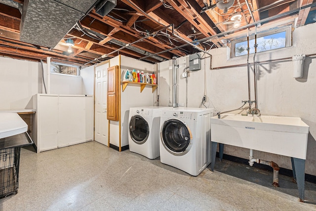 laundry room with washing machine and clothes dryer, laundry area, and light floors