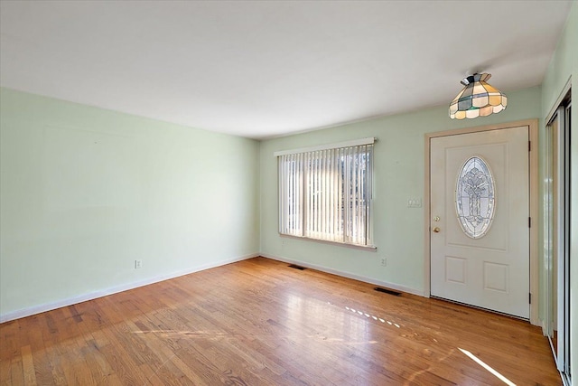 entrance foyer featuring visible vents, baseboards, and hardwood / wood-style floors