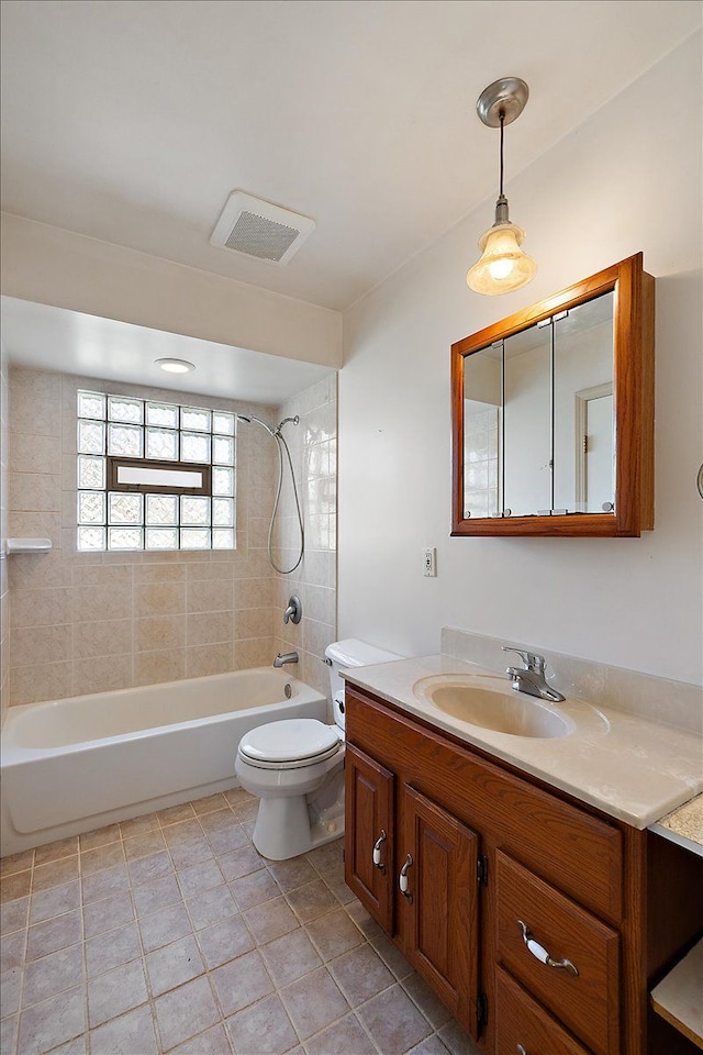 bathroom with vanity, visible vents, tub / shower combination, tile patterned flooring, and toilet