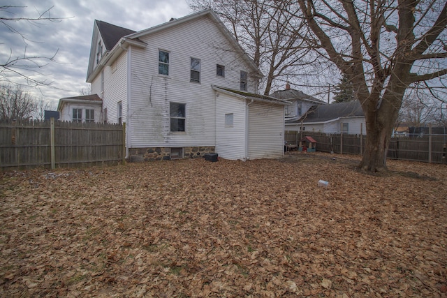 back of property with fence