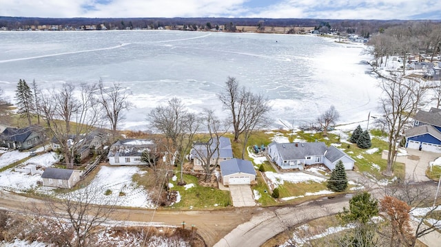 snowy aerial view with a residential view