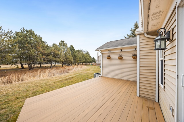 wooden terrace featuring a lawn