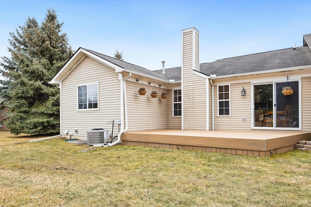 back of property featuring central AC, a lawn, a chimney, and a wooden deck