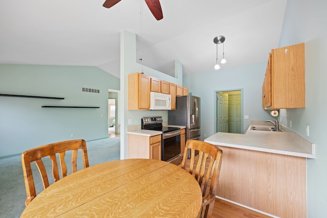 kitchen with visible vents, lofted ceiling, stainless steel appliances, light countertops, and a sink