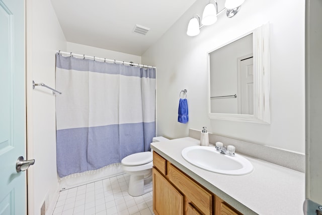 bathroom featuring visible vents, vanity, toilet, and tile patterned floors