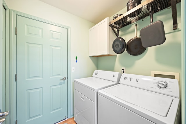 laundry area featuring cabinet space and washing machine and clothes dryer