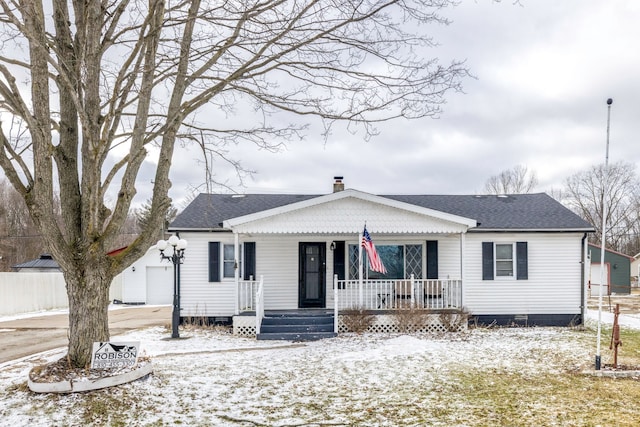 bungalow-style house with a garage, a shingled roof, a chimney, covered porch, and fence