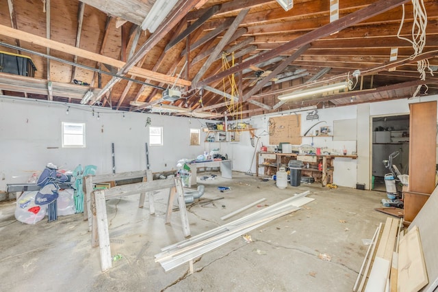 garage with a workshop area and a garage door opener