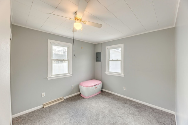 carpeted spare room featuring a healthy amount of sunlight, baseboards, electric panel, and visible vents