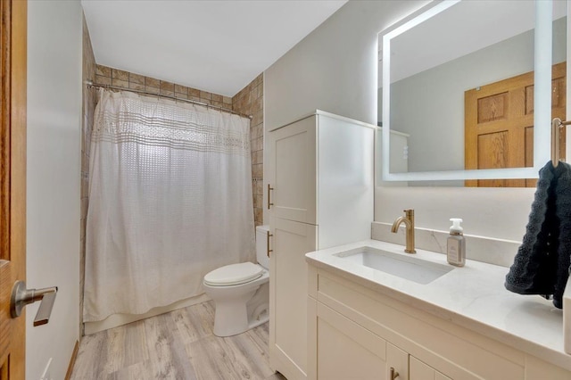 full bath with vanity, wood finished floors, toilet, and shower / bathtub combination with curtain