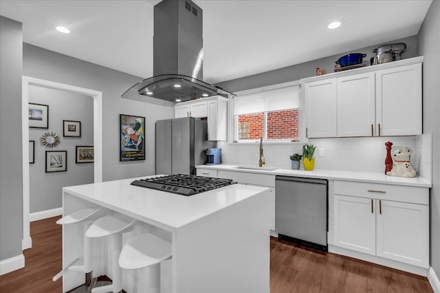 kitchen with white cabinetry, stainless steel appliances, dark wood-type flooring, and island range hood