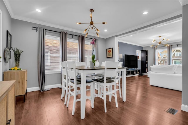 dining room with crown molding, a notable chandelier, a healthy amount of sunlight, and visible vents