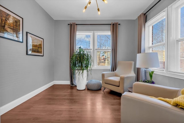 sitting room featuring baseboards and wood finished floors