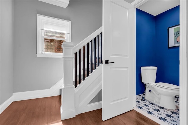 stairs with wood finished floors and baseboards