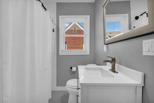 bathroom featuring vanity, curtained shower, toilet, and baseboards