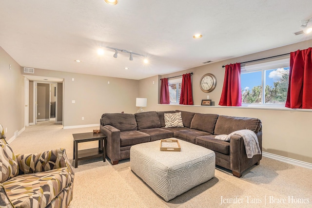 living area with light carpet, baseboards, visible vents, and recessed lighting