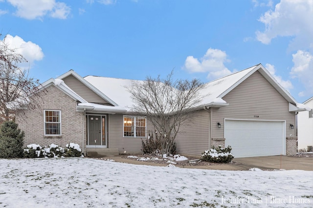 single story home featuring a garage and brick siding