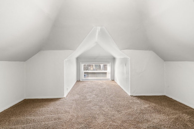 bonus room with carpet and lofted ceiling