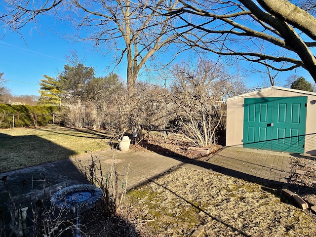 view of yard with an outbuilding, a storage shed, and fence