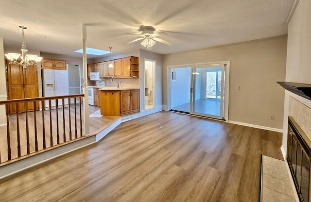 kitchen featuring white appliances, baseboards, open shelves, light countertops, and light wood-style floors