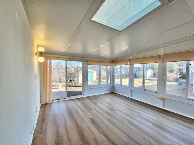 unfurnished sunroom featuring a skylight