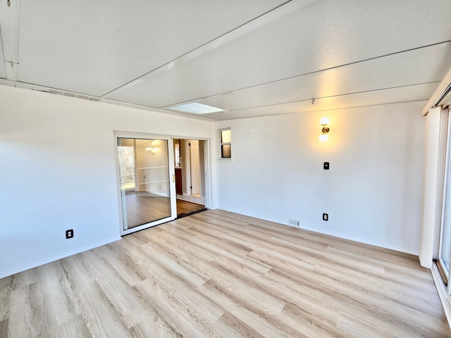 unfurnished room with visible vents and light wood-style flooring