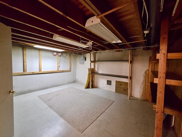 unfinished basement with tile patterned floors and electric panel