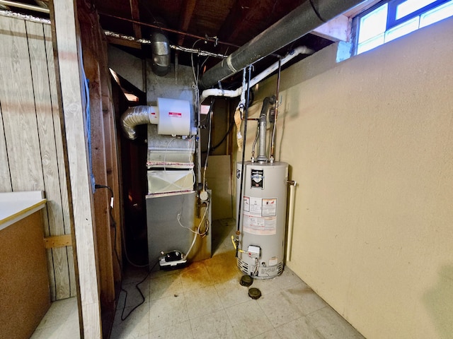 utility room with heating unit and water heater