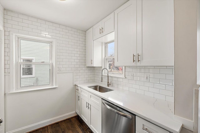 kitchen with decorative backsplash, dark wood-type flooring, white cabinets, a sink, and dishwasher