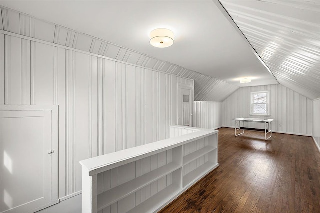 additional living space featuring lofted ceiling and dark wood-type flooring