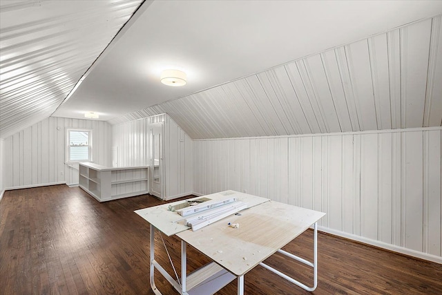 additional living space with vaulted ceiling and dark wood-style flooring