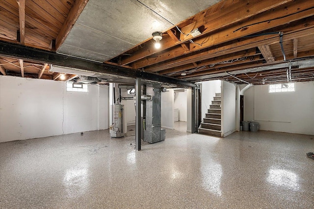 basement with stairs, gas water heater, and heating unit