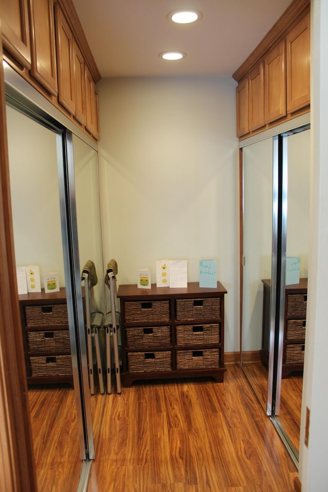 interior space with dark wood finished floors, recessed lighting, and baseboards