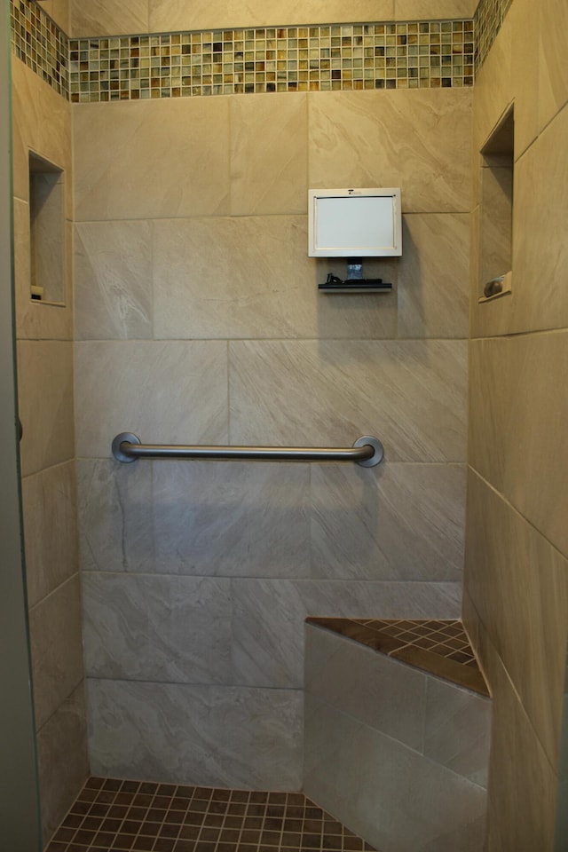 full bathroom with a tile shower