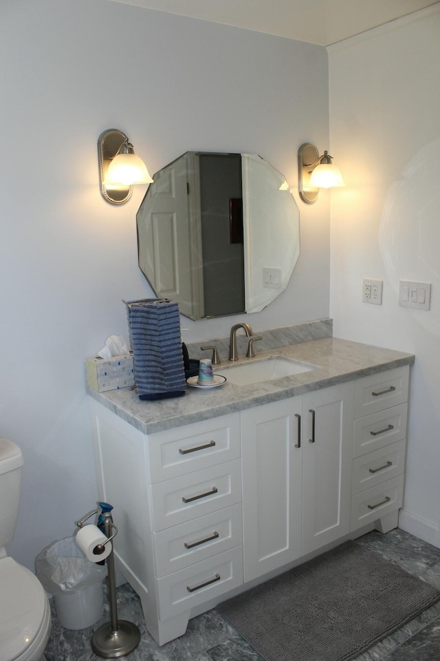 half bathroom featuring toilet and vanity