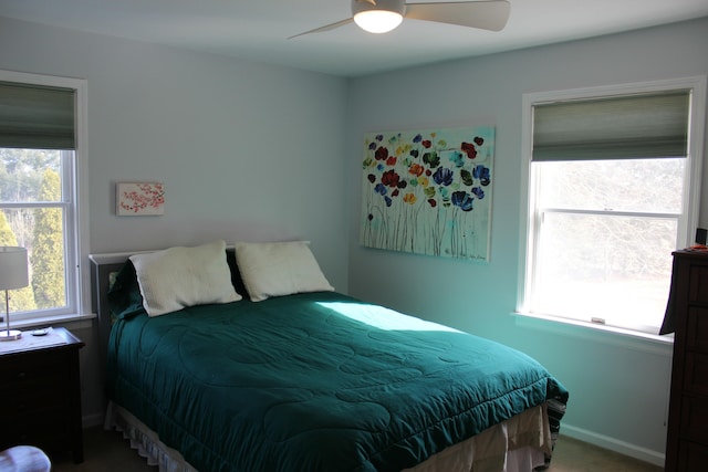 bedroom featuring baseboards, carpet floors, and ceiling fan