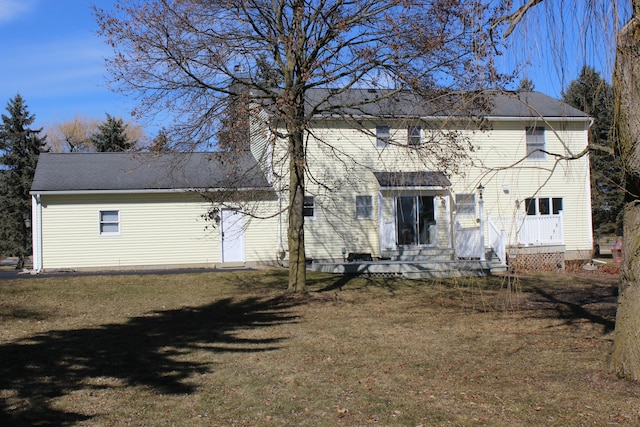 rear view of property with a yard