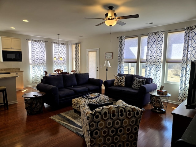 living room featuring ceiling fan, baseboards, dark wood finished floors, and recessed lighting