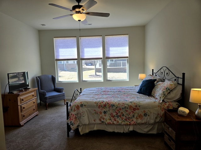 carpeted bedroom featuring visible vents and ceiling fan