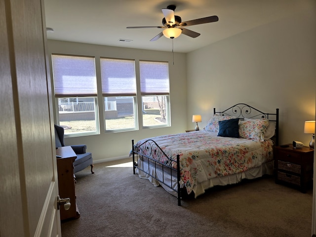 carpeted bedroom featuring visible vents and a ceiling fan