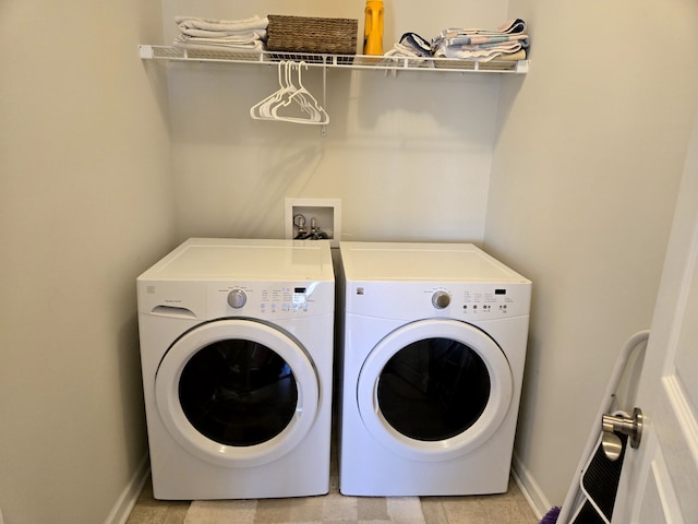 washroom with washer and dryer, laundry area, and baseboards