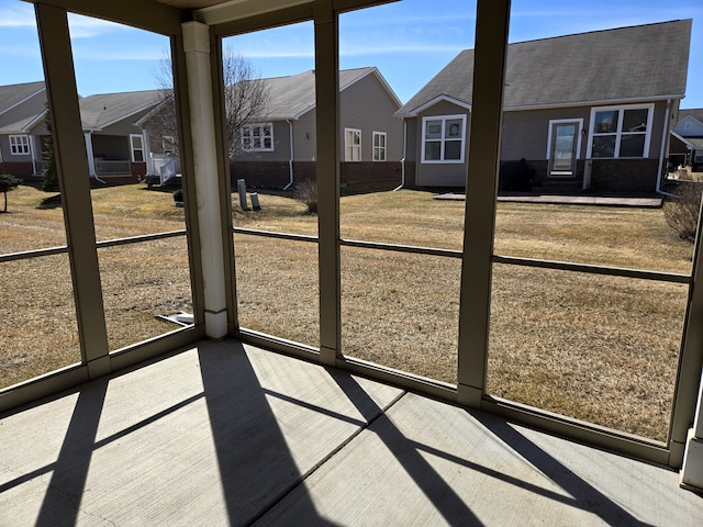 unfurnished sunroom with a residential view