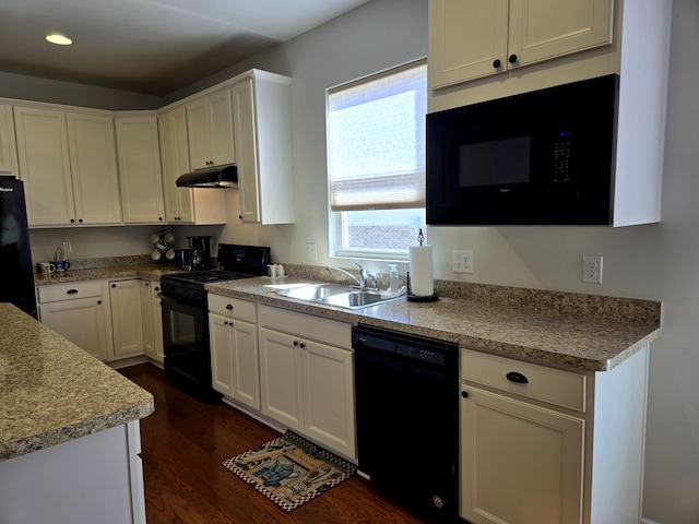 kitchen featuring black appliances, a sink, white cabinets, and under cabinet range hood