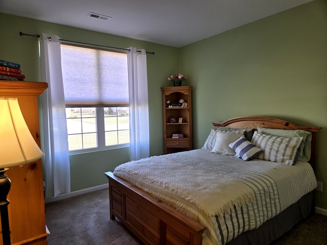 bedroom with baseboards, visible vents, and carpet flooring