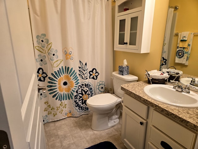 full bathroom with toilet and vanity